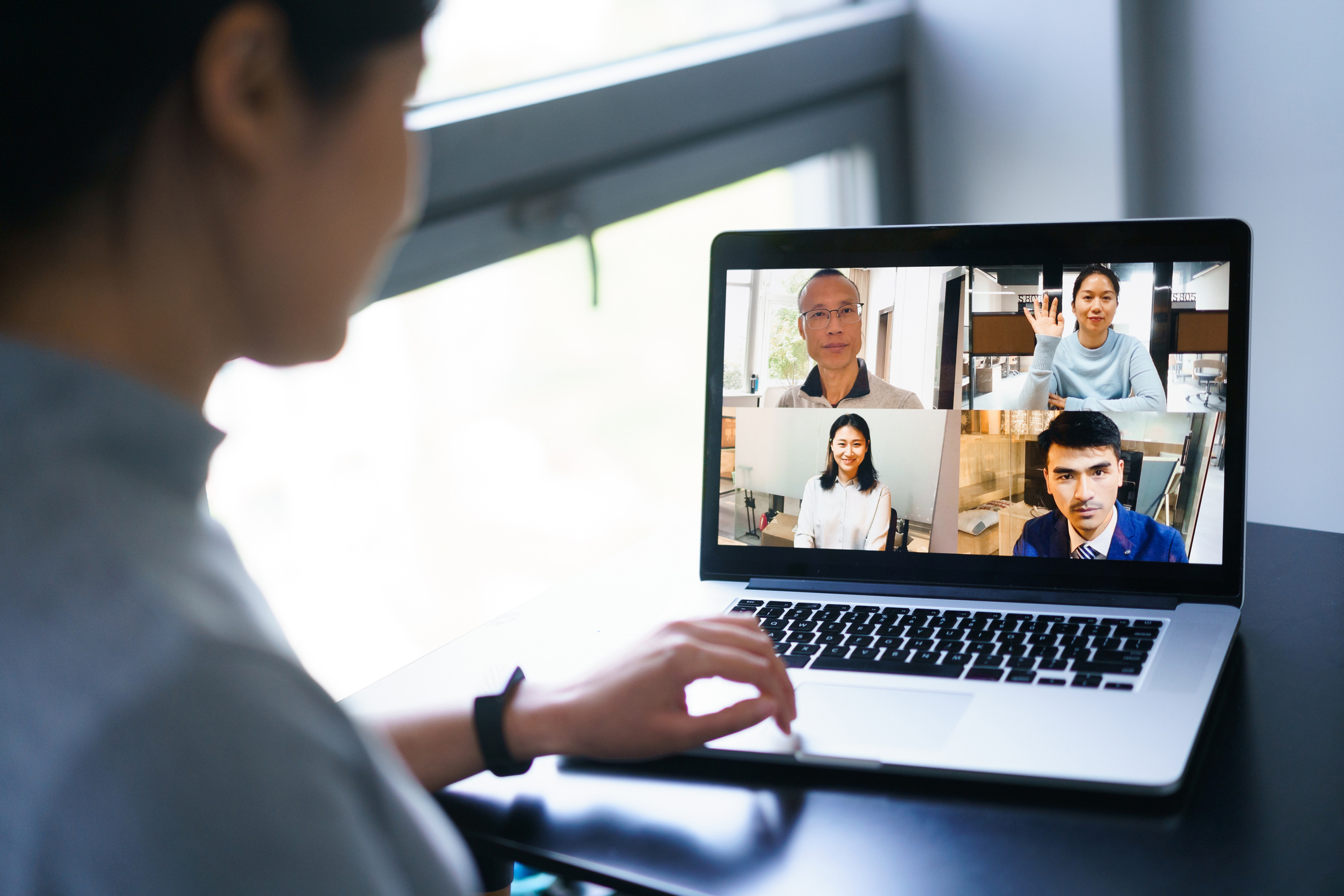 asian female having conference call on laptop