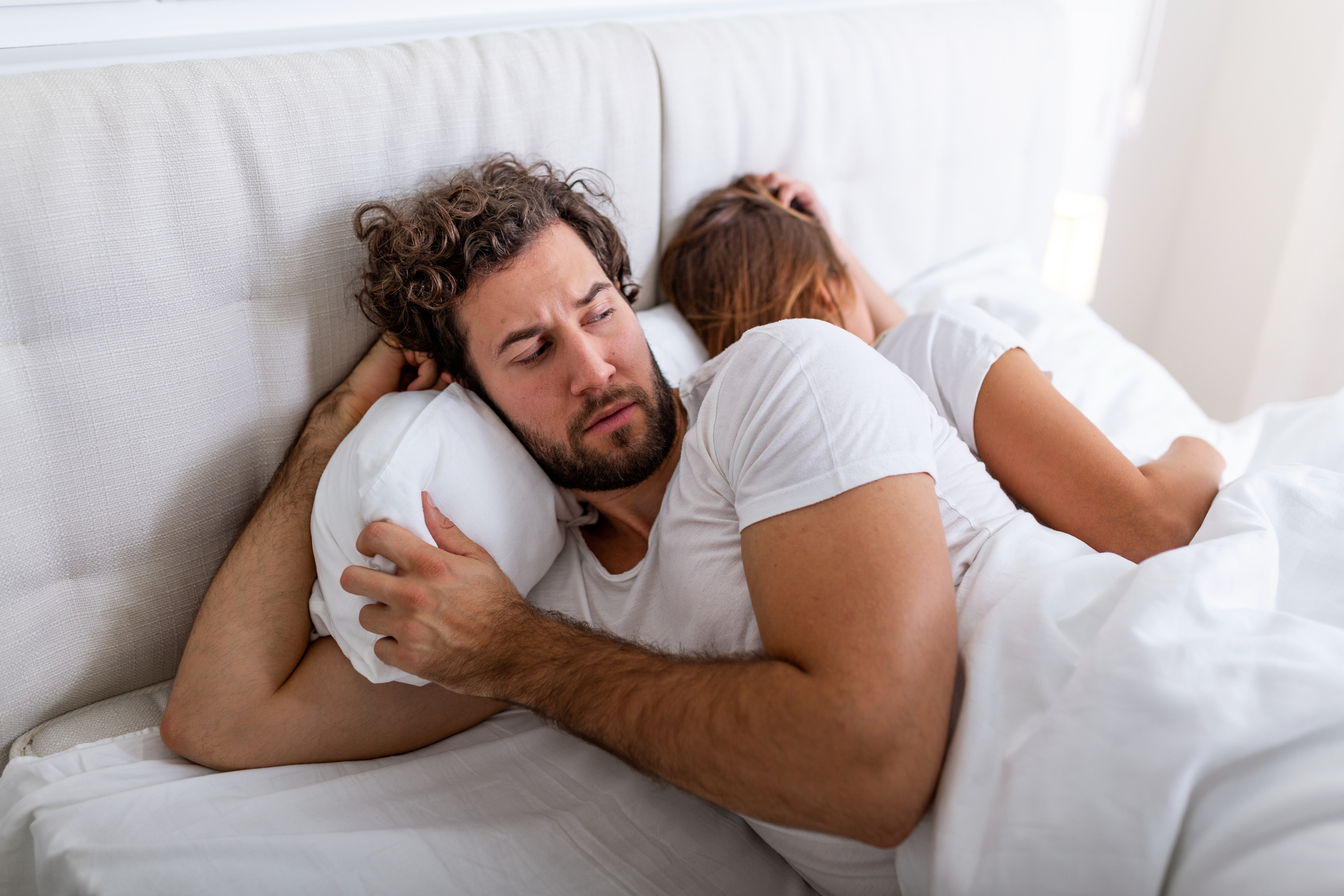 Relationship concept. Top view of young couple lying on the bed. Couple having a fight in the bed. concept about relationship and problems between couples. Sexual frustration. Lovers ignore each other